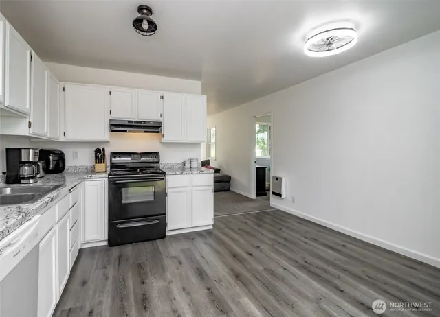 a kitchen with a refrigerator and a stove top oven