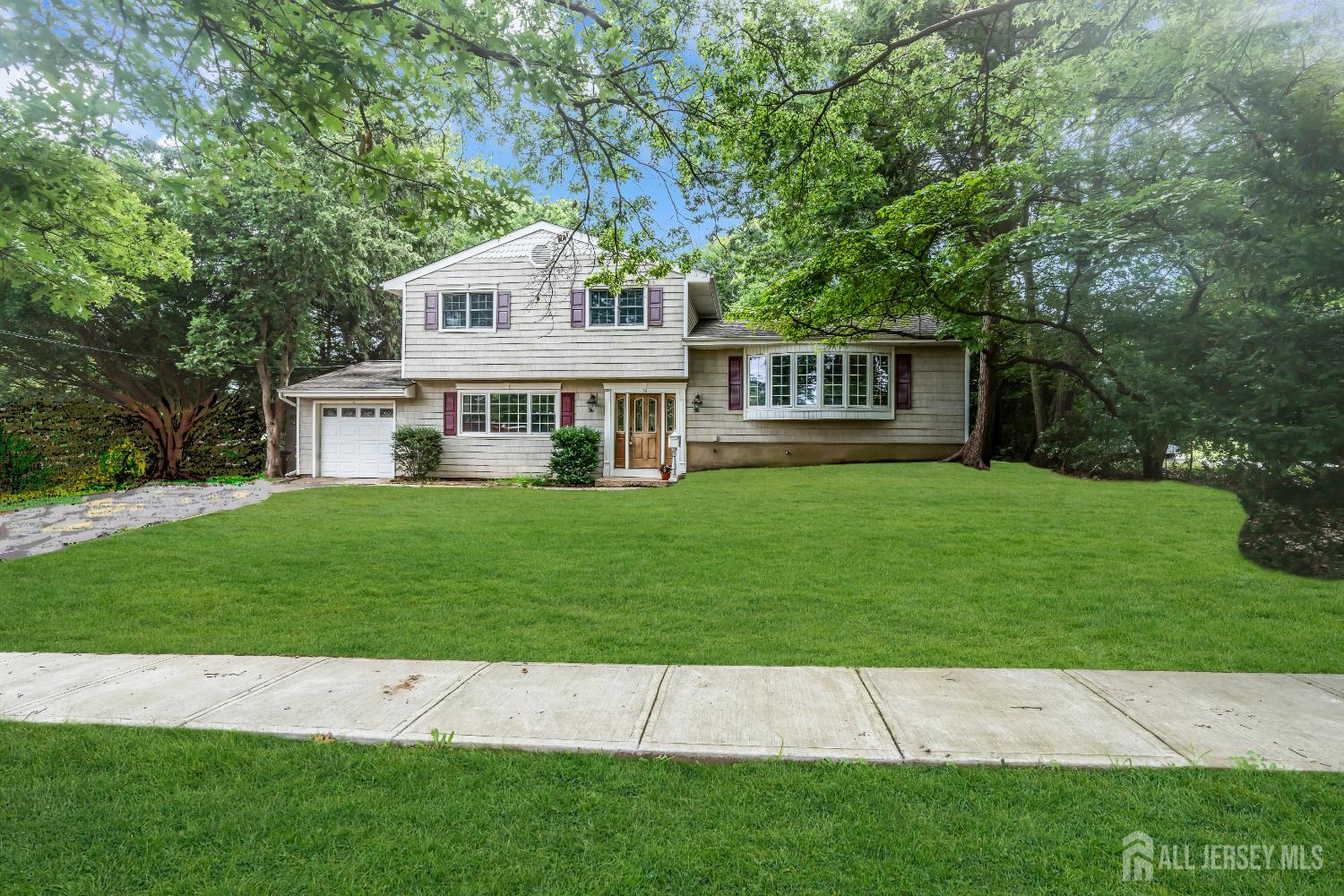 a front view of a house with a garden and yard