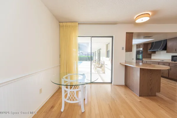 a kitchen with stainless steel appliances granite countertop a sink and cabinets with wooden floor