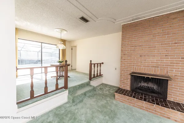 a view of a livingroom with furniture and a fireplace