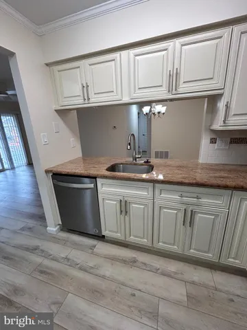 a kitchen with granite countertop a sink and cabinets