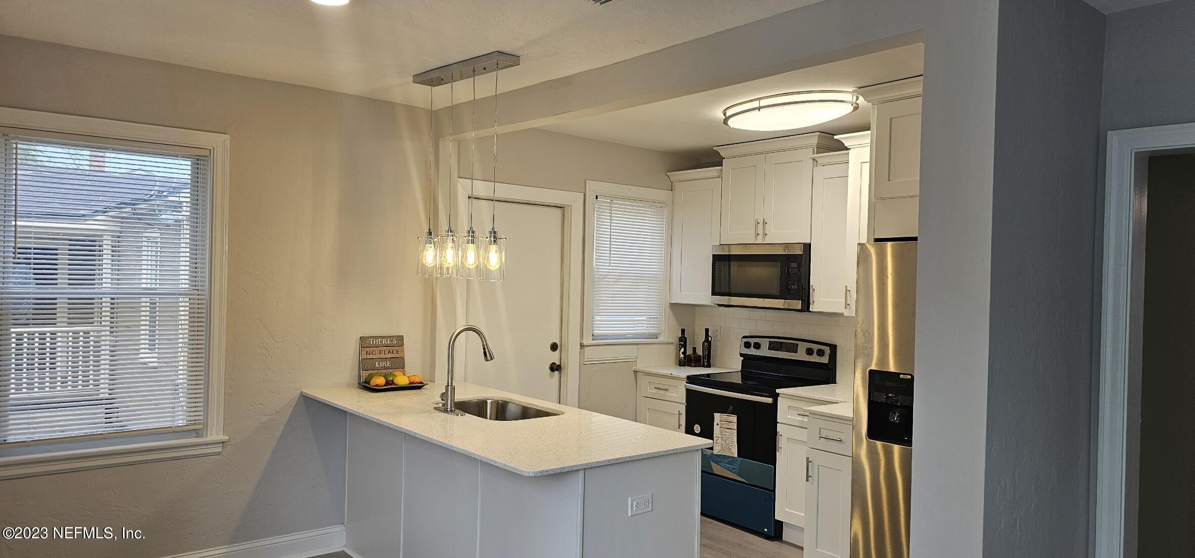 5232 Sunderland Road Jacksonville, FL 32210 - Photo 4 of 17 a kitchen with a sink stove and refrigerator