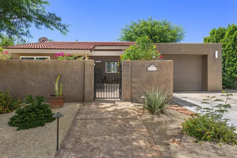 a view of a front door and a yard