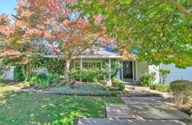 a front view of a house with garden