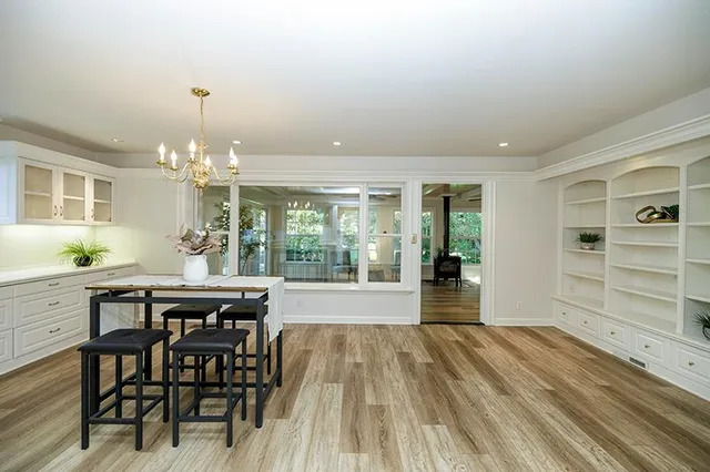 a kitchen with granite countertop white cabinets and stainless steel appliances