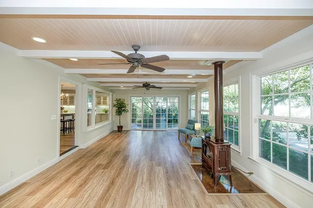 a spacious bedroom with a bed and a chandelier