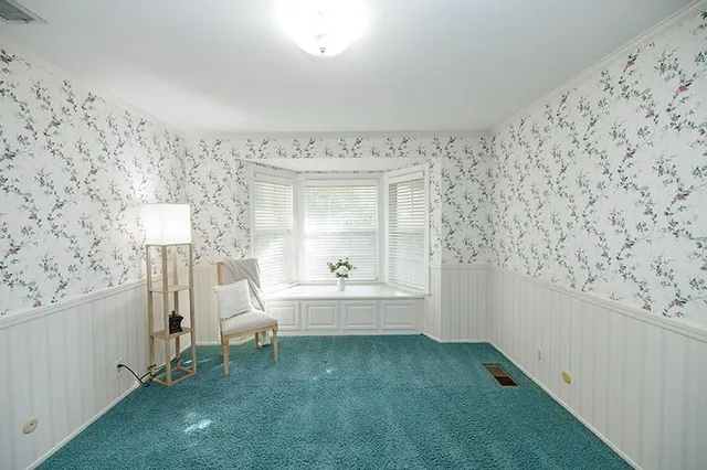 a view of an empty room with a ceiling fan