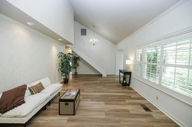 a living room with furniture and wooden floor