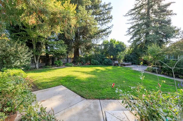 an aerial view of a house with a yard and garden