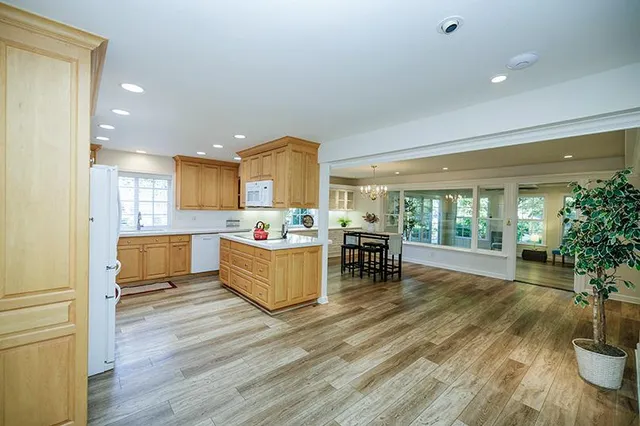 a kitchen with white cabinets and refrigerator
