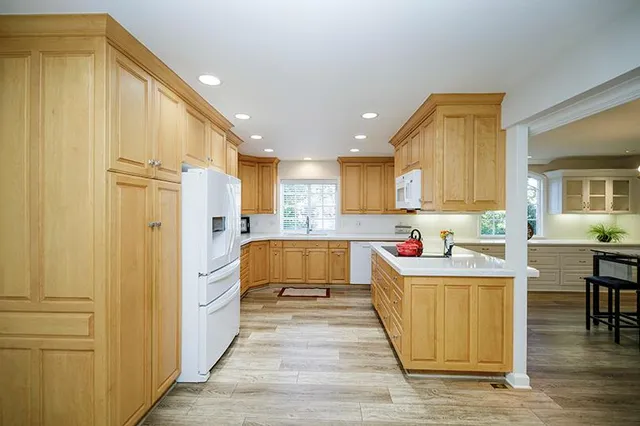 a kitchen with a sink a stove and cabinets