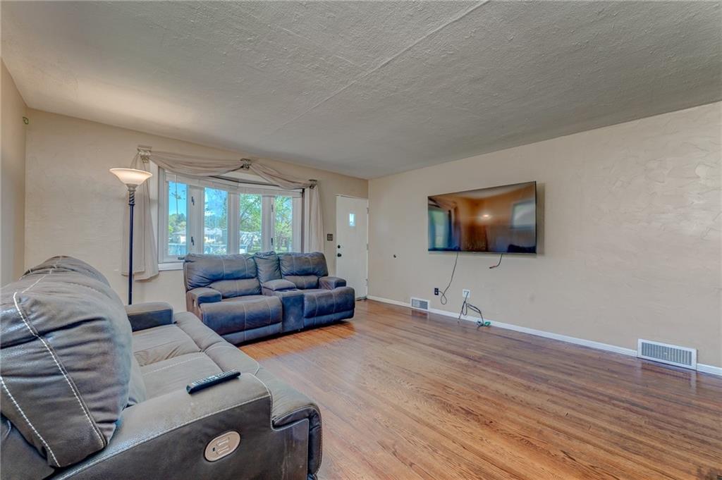 717 Morgantown Road Uniontown, PA 15401 - Photo 14 of 23 a living room with furniture and a flat screen tv