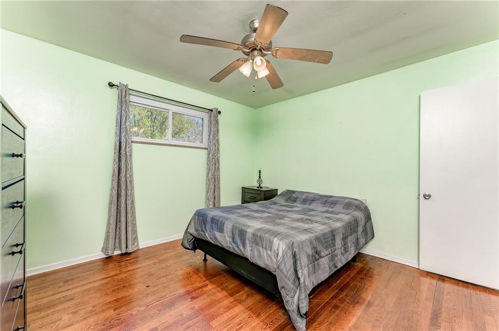 717 Morgantown Road Uniontown, PA 15401 - Photo 17 of 23 a bedroom with a bed and a table with wooden floor