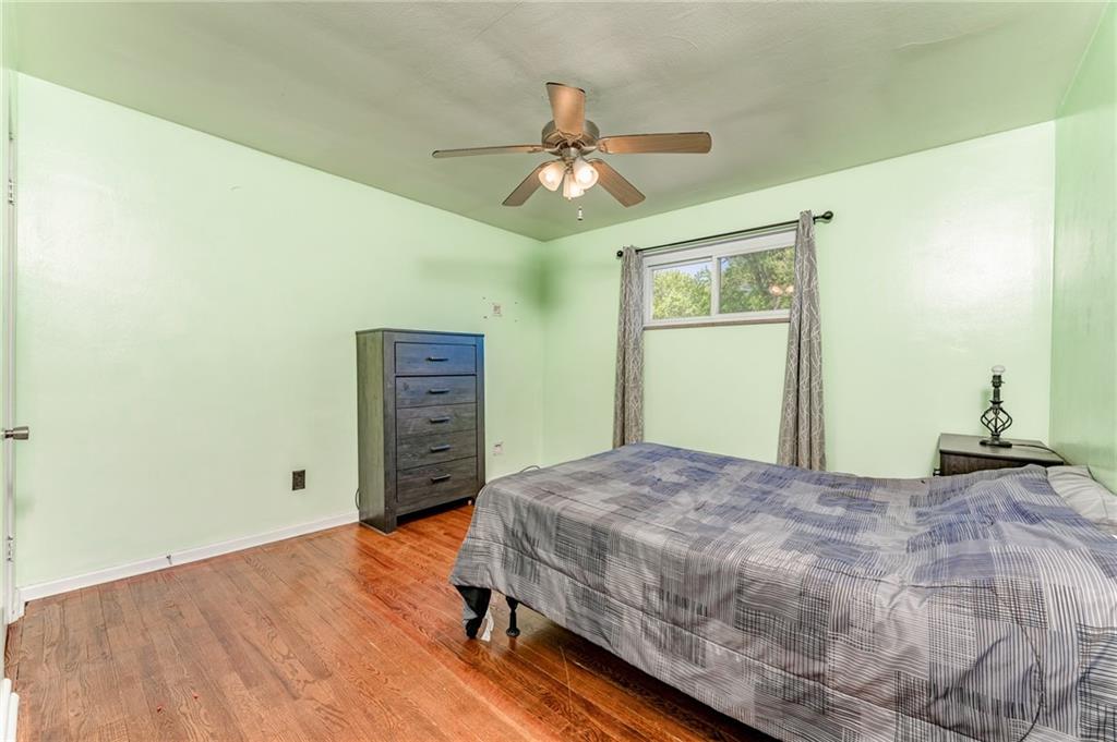 717 Morgantown Road Uniontown, PA 15401 - Photo 18 of 23 a bedroom with a bed and a chandelier