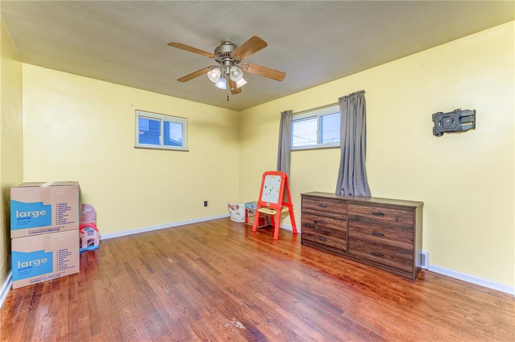 717 Morgantown Road Uniontown, PA 15401 - Photo 19 of 23 a bedroom with a bed and wooden floor