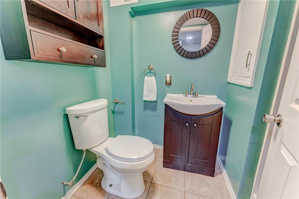 717 Morgantown Road Uniontown, PA 15401 - Photo 21 of 23 a bathroom with a toilet a sink and mirror