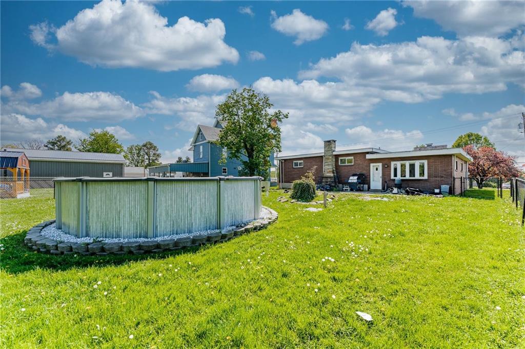 717 Morgantown Road Uniontown, PA 15401 - Photo 3 of 23 a view of a house with a big yard potted plants and large tree