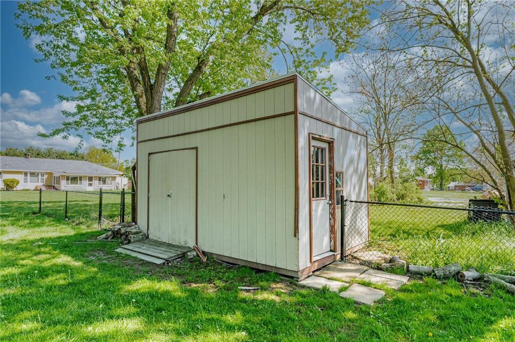 717 Morgantown Road Uniontown, PA 15401 - Photo 6 of 23 a backyard of a house with a large tree and wooden fence