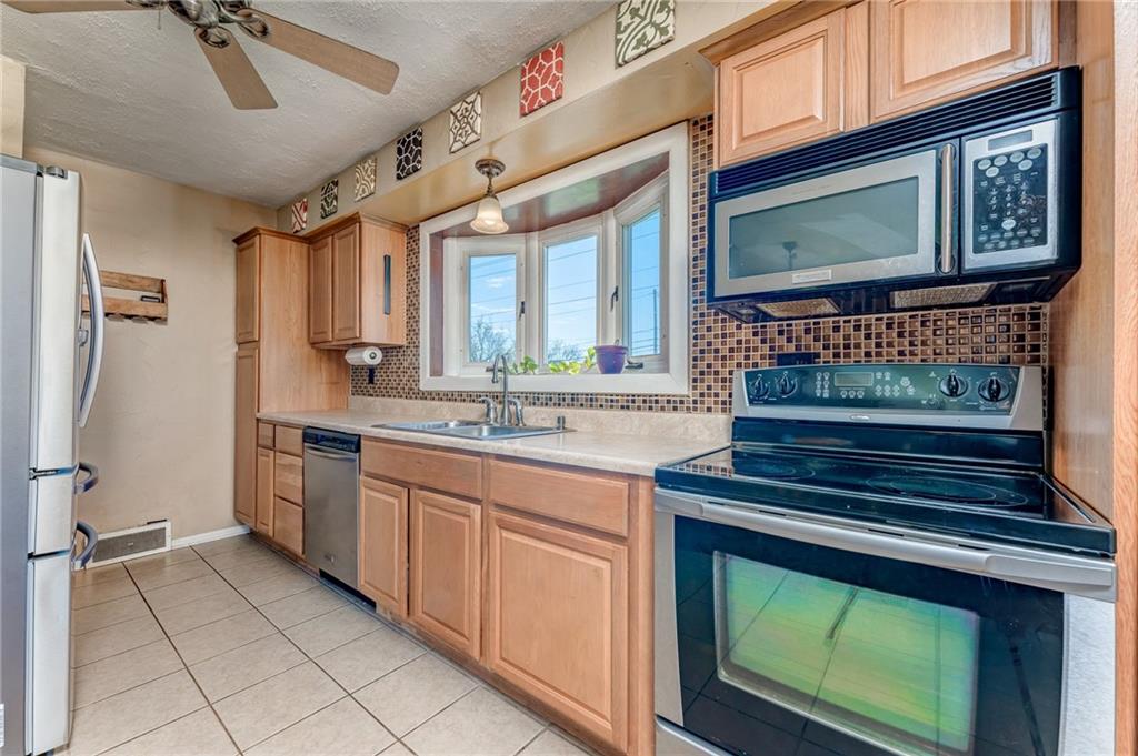 717 Morgantown Road Uniontown, PA 15401 - Photo 8 of 23 a kitchen with stainless steel appliances granite countertop a stove and a microwave