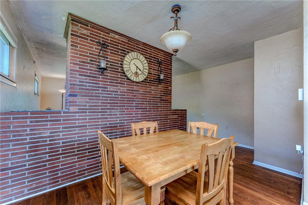 717 Morgantown Road Uniontown, PA 15401 - Photo 10 of 23 a brick wall with a sink and a chair