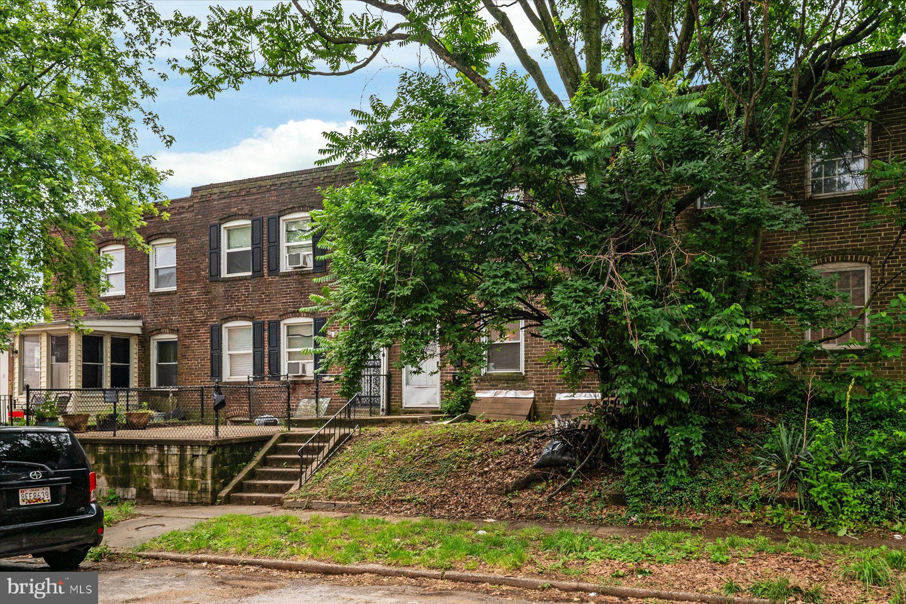 613 Baltic Avenue Baltimore, MD 21225 - Photo 1 of 6 a front view of a house with a yard