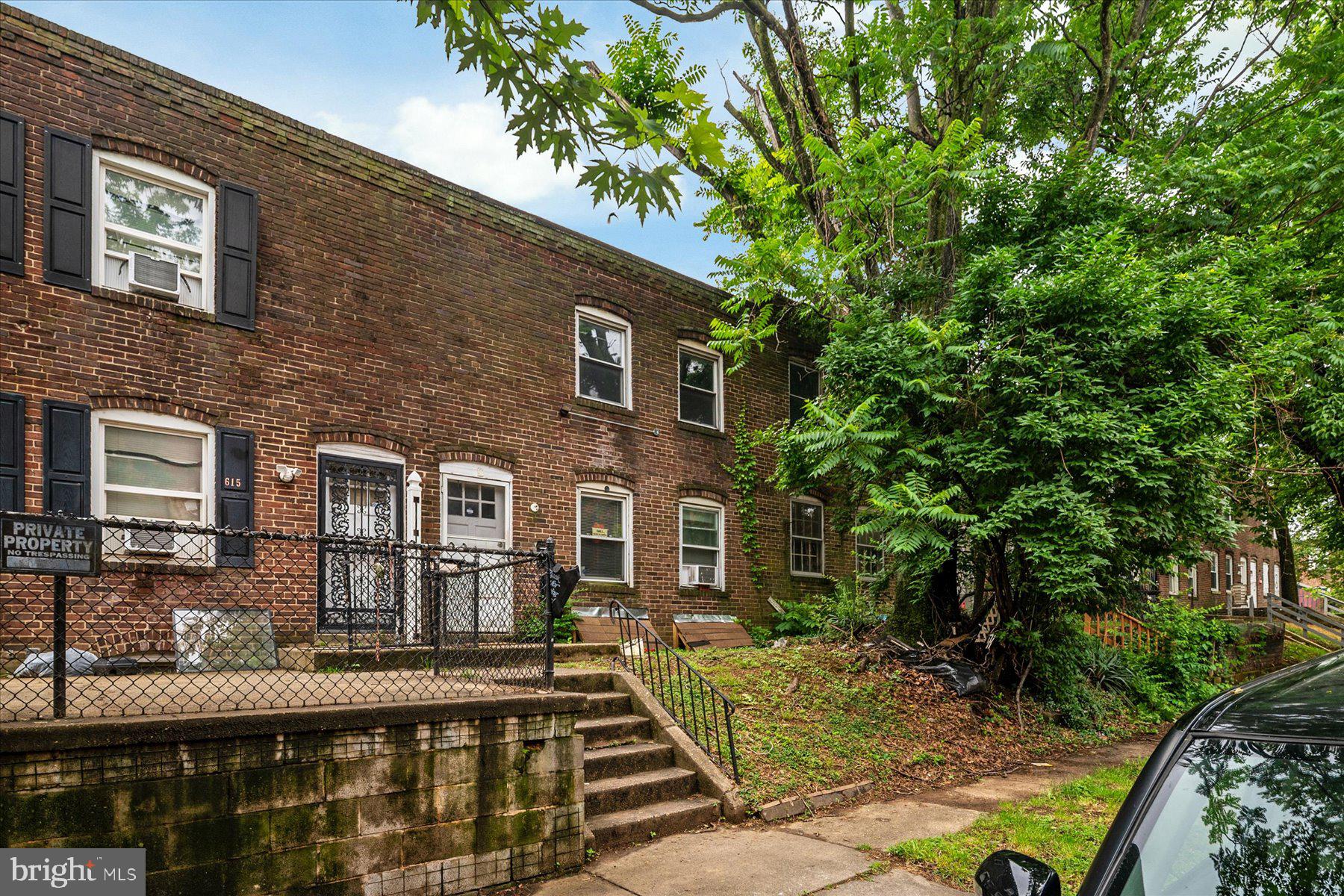 613 Baltic Avenue Baltimore, MD 21225 - Photo 3 of 6 a front view of a house with garden