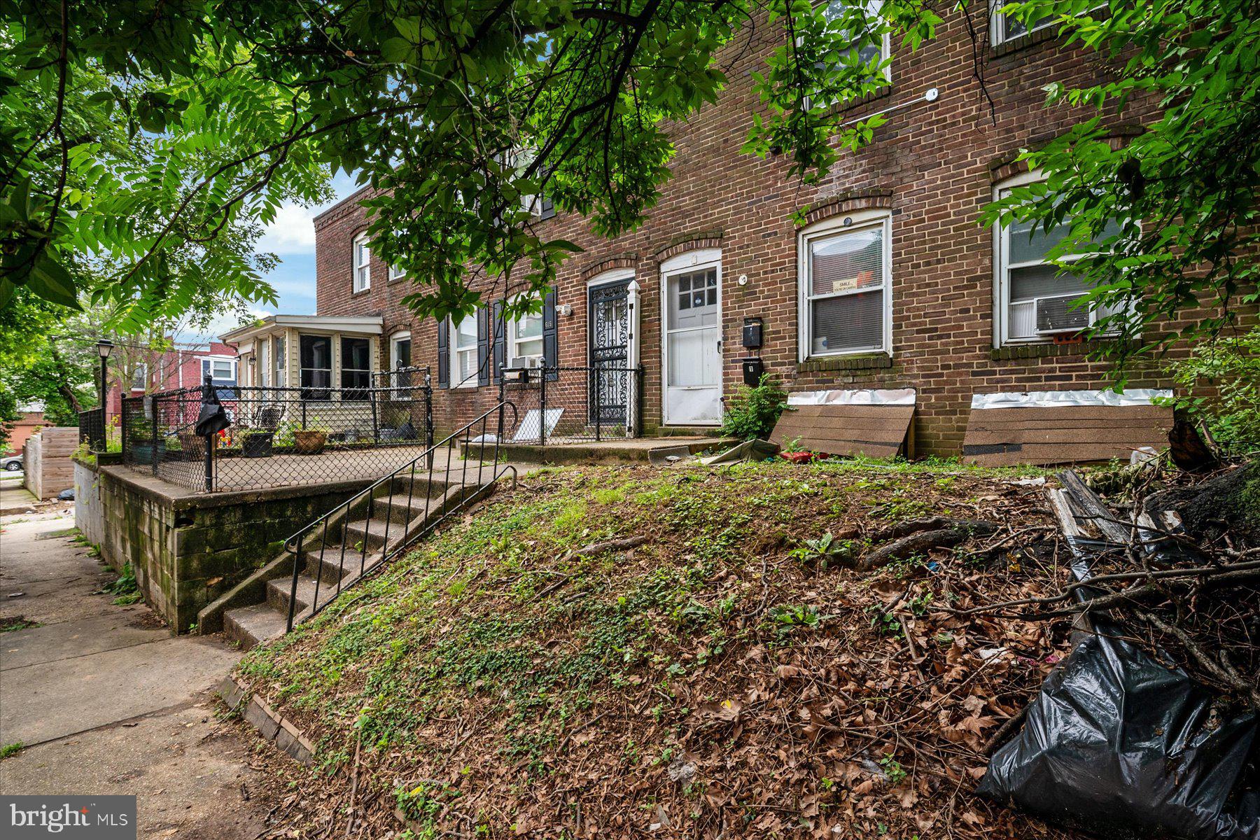613 Baltic Avenue Baltimore, MD 21225 - Photo 6 of 6 a front view of house with yard and sitting area