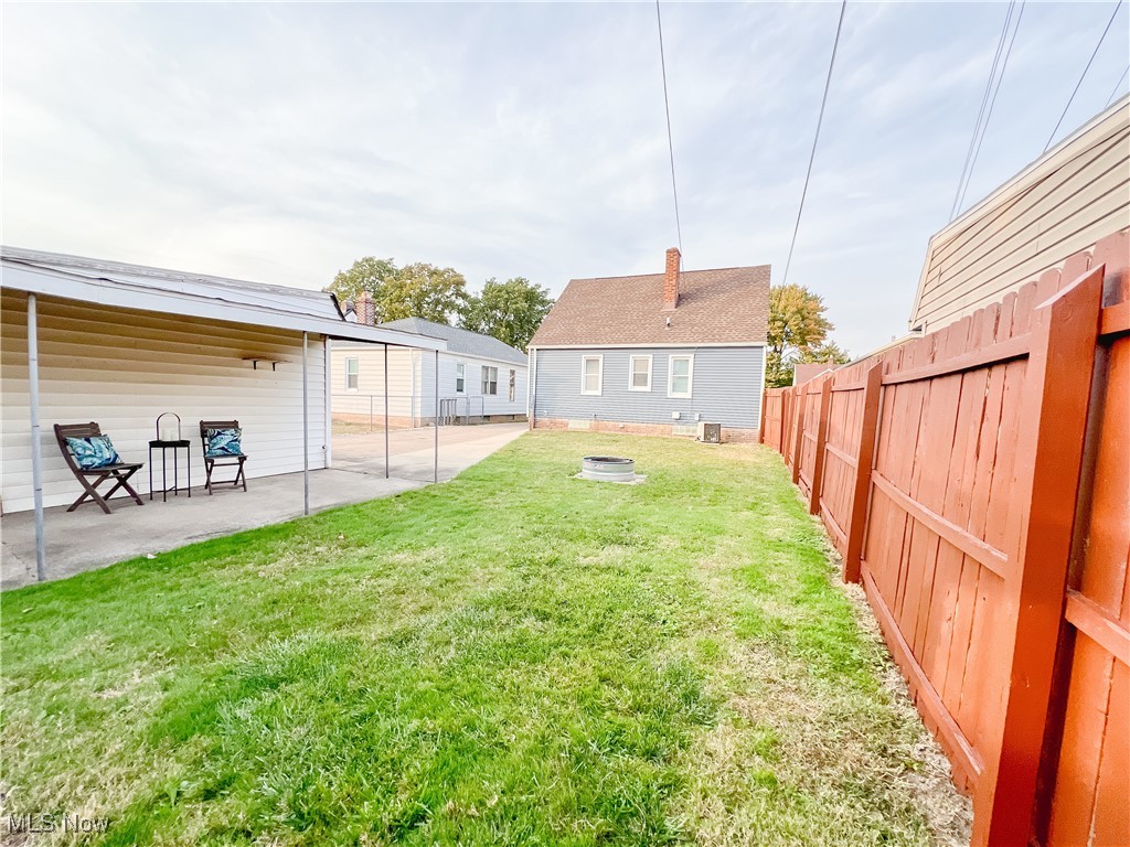 6403 Kenneth Avenue Parma, OH 44129 - Photo 3 of 20 Fenced backyard with an outdoor fire pit and a patio