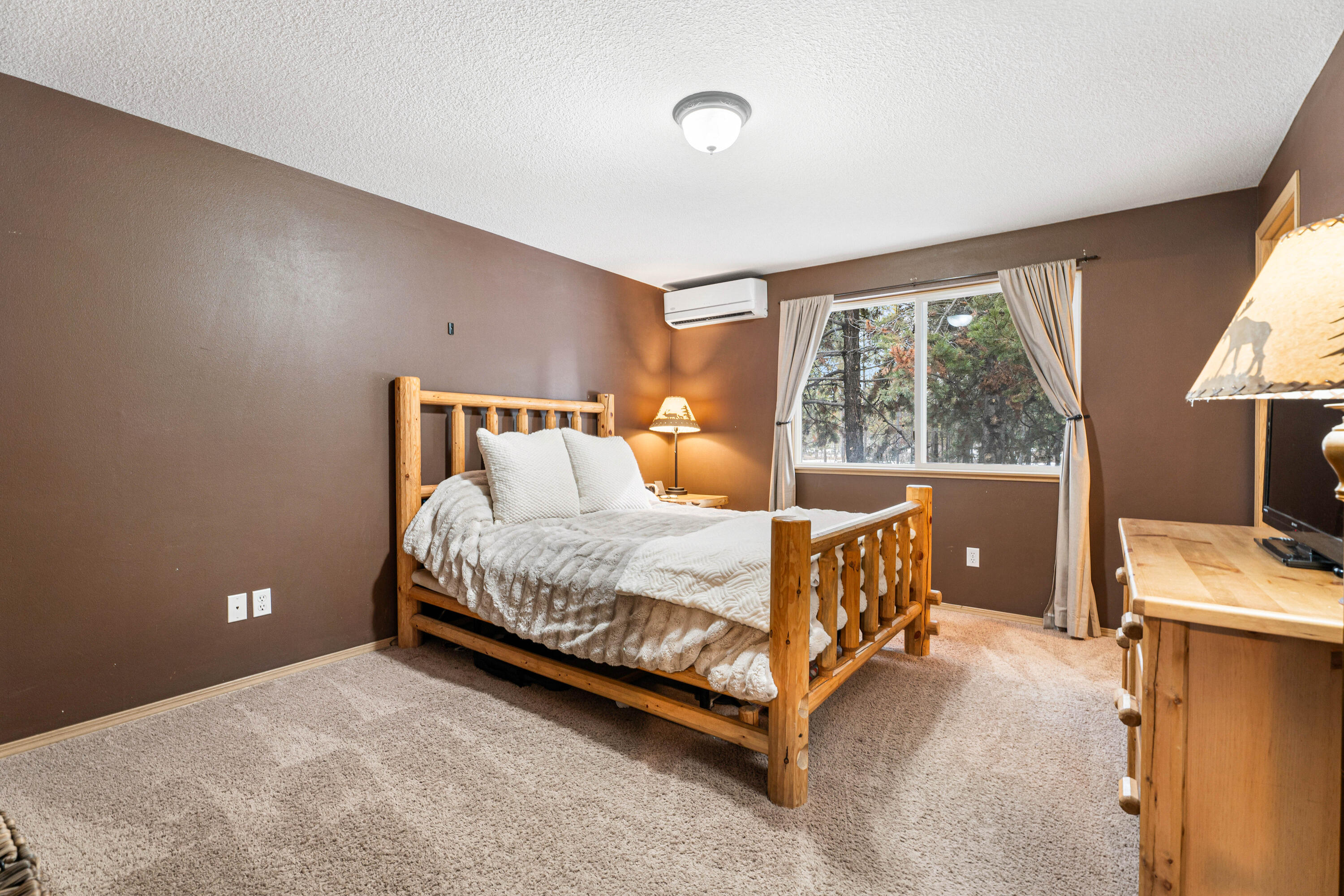 16939 Torrance Road Bend, OR 97707 - Photo 19 of 33 a bed sitting in a bedroom next to a window