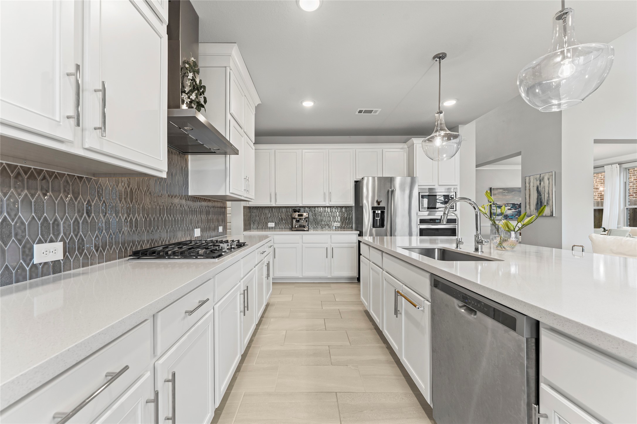 8815 Iron Forge Road Missouri City, TX 77459 - Photo 12 of 40 a large kitchen with stainless steel appliances lots of counter space sink and cabinets
