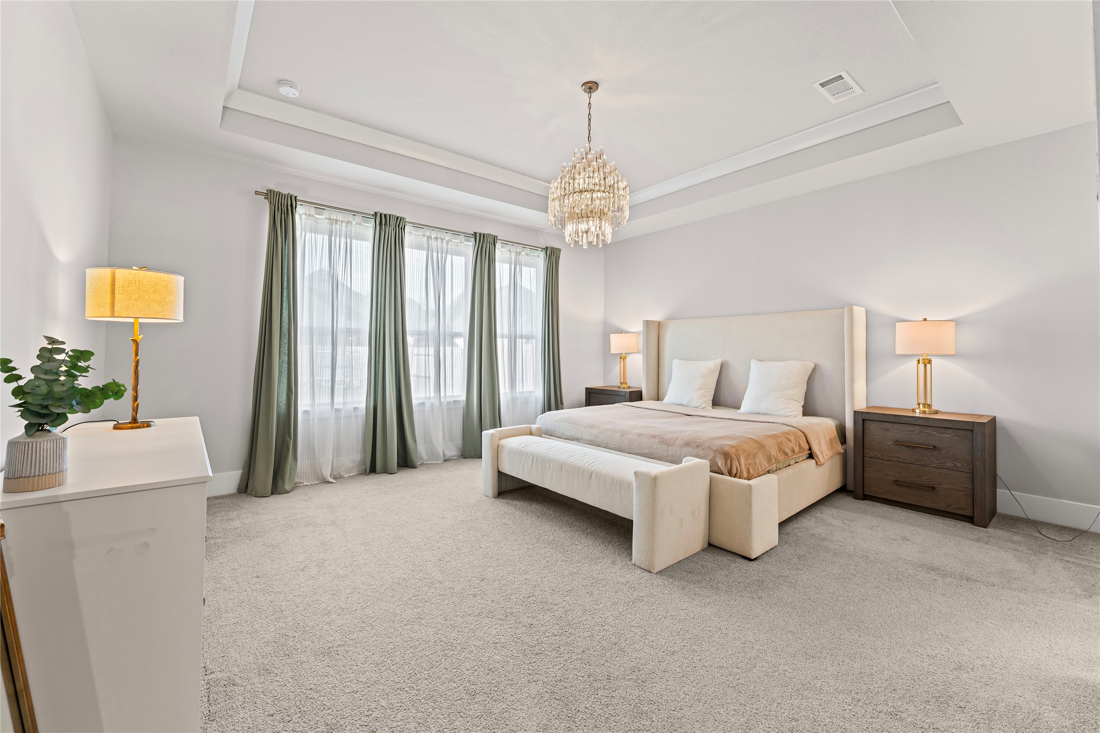 8815 Iron Forge Road Missouri City, TX 77459 - Photo 18 of 40 a spacious bedroom with a bed and a chandelier