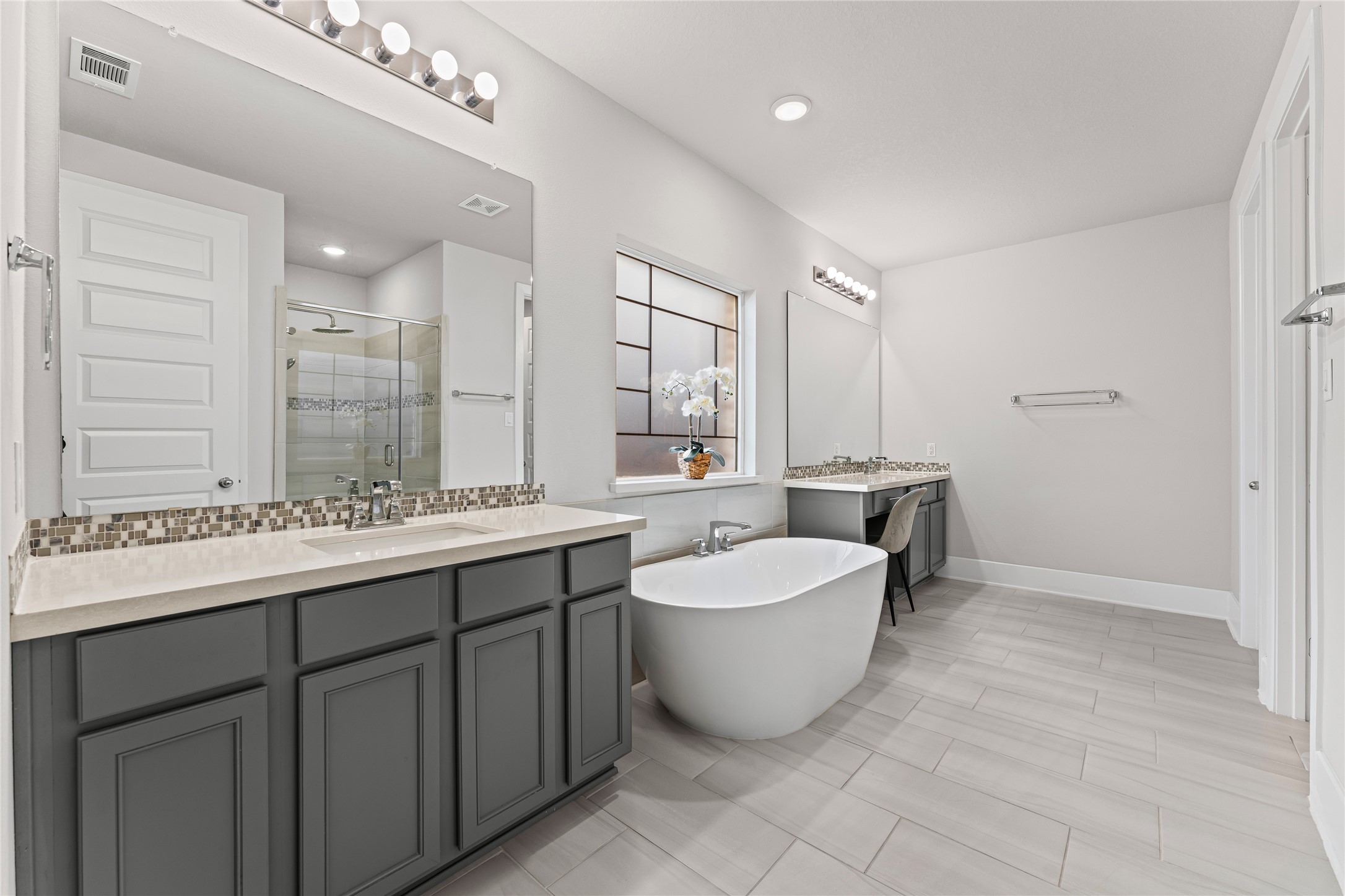 8815 Iron Forge Road Missouri City, TX 77459 - Photo 19 of 40 a spacious bathroom with a double vanity sink mirror and bathtub