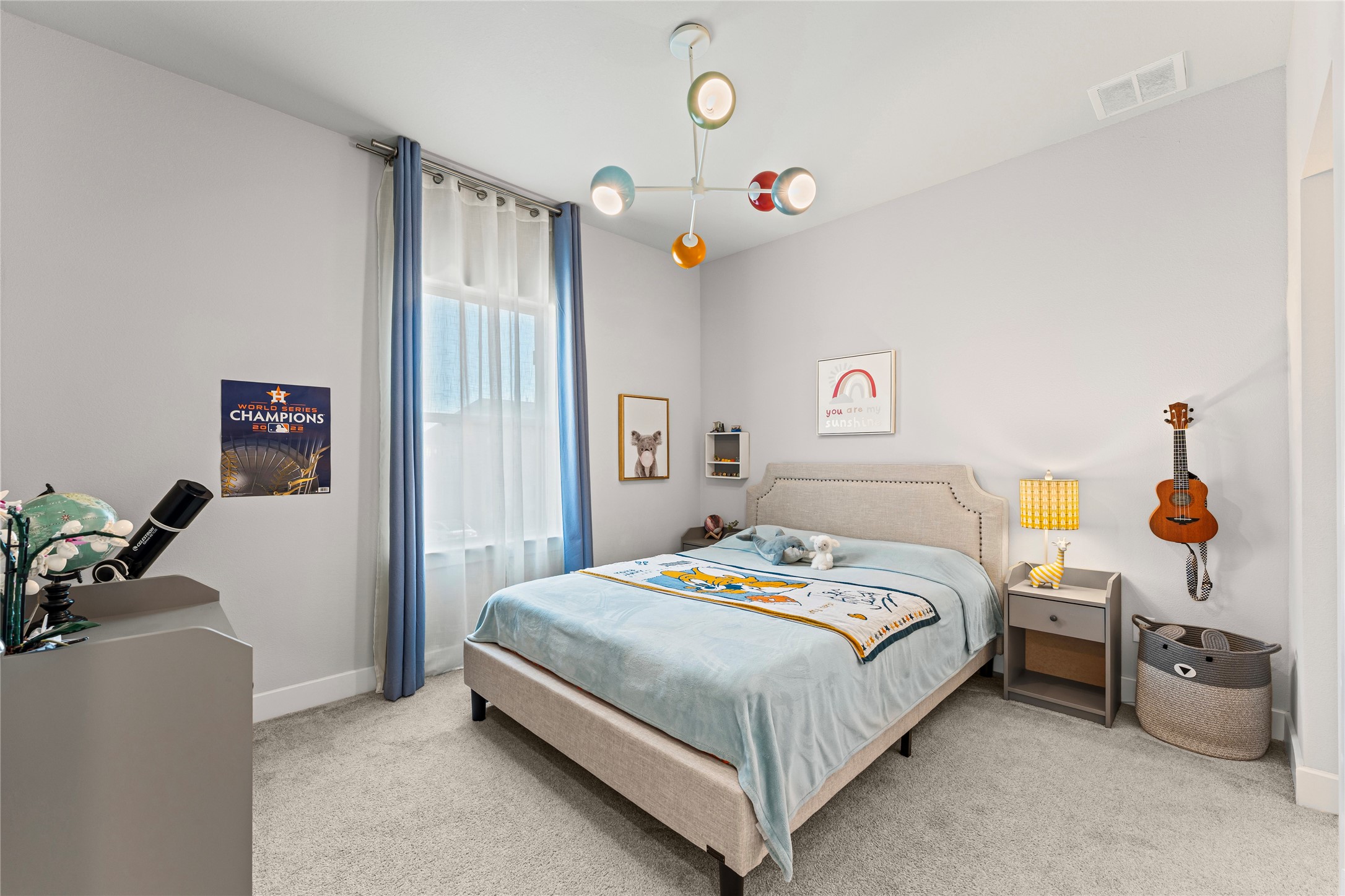 8815 Iron Forge Road Missouri City, TX 77459 - Photo 31 of 40 a bedroom with a bed and a chandelier