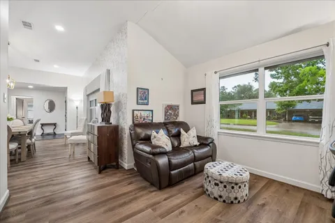 a living room with furniture and wooden floor