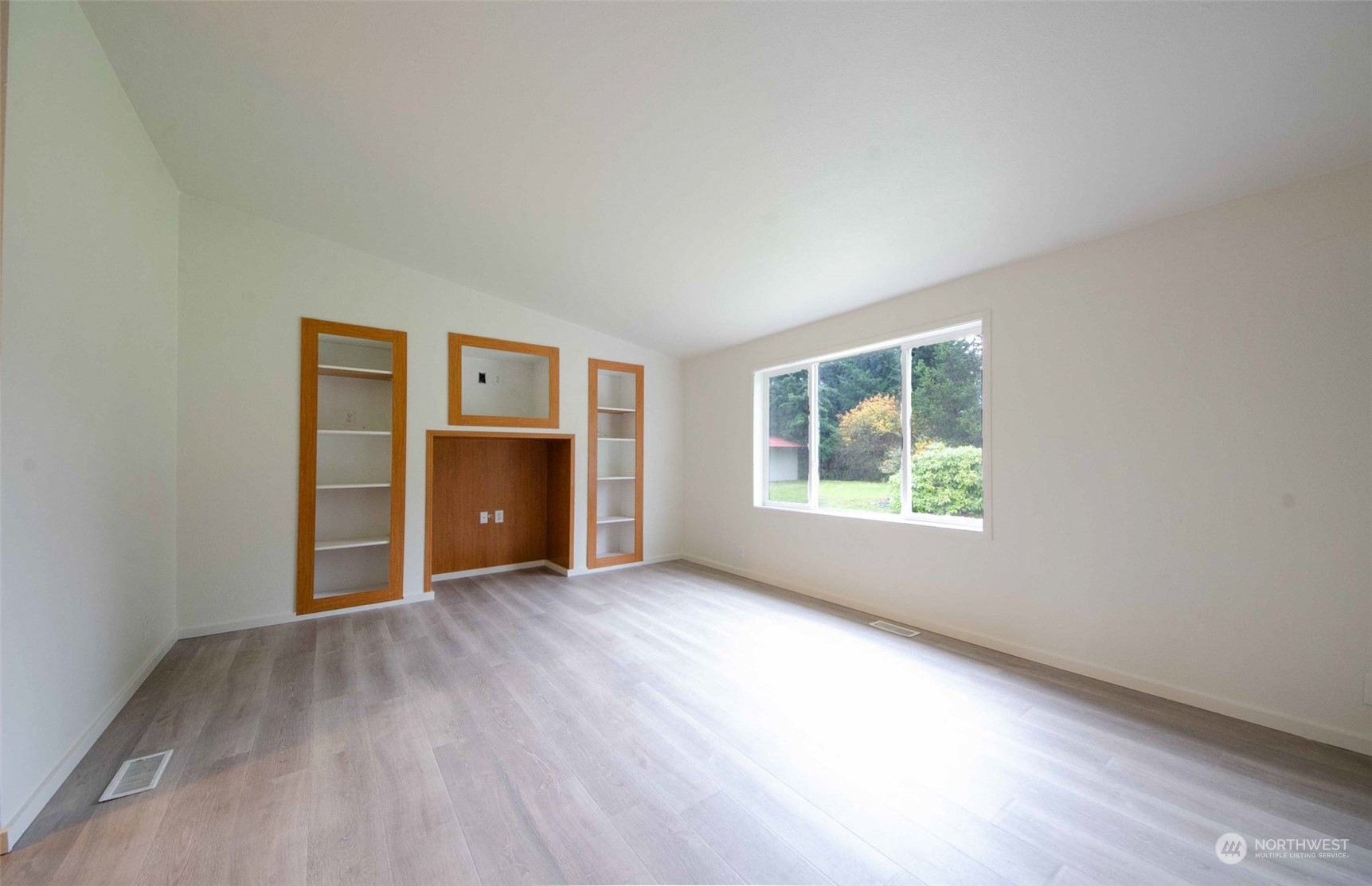 8827 173rd Avenue Southwest Rochester, WA 98579 - Photo 7 of 15 an empty room with wooden floor and windows
