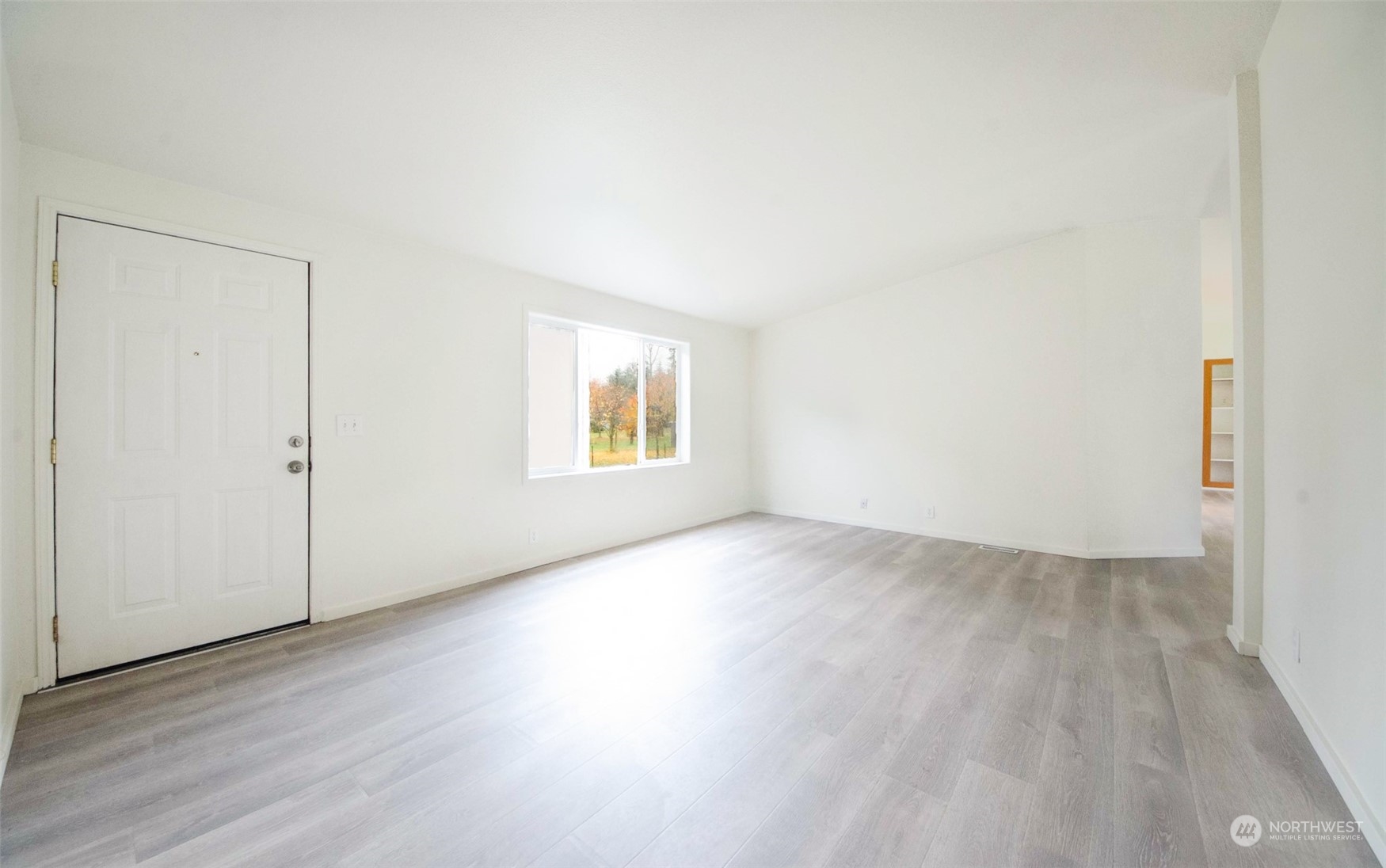 8827 173rd Avenue Southwest Rochester, WA 98579 - Photo 8 of 15 an empty room with wooden floor and windows