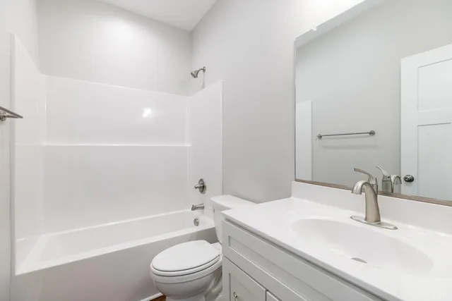 a bathroom with a sink a toilet and a bathtub