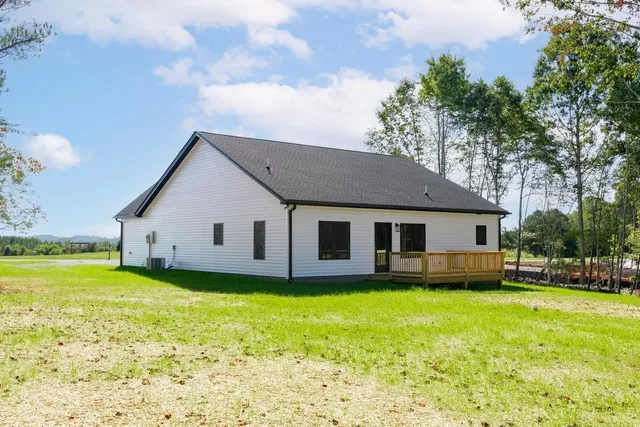 a front view of house with yard and swimming pool
