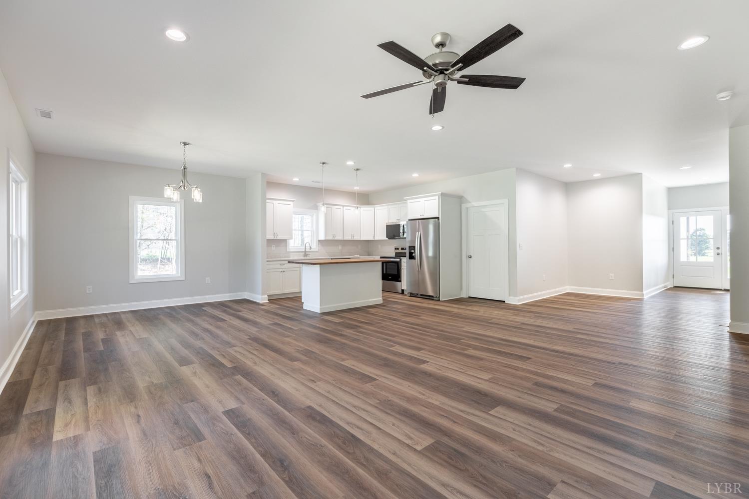 757 Down Creek Road Brookneal, VA 24528 - Photo 4 of 49 a view of an empty room with wooden floor and a kitchen