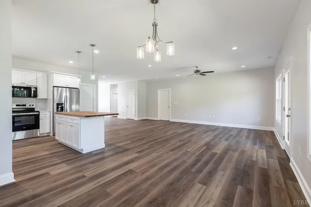 a view of kitchen with cabinets appliances and wooden floor