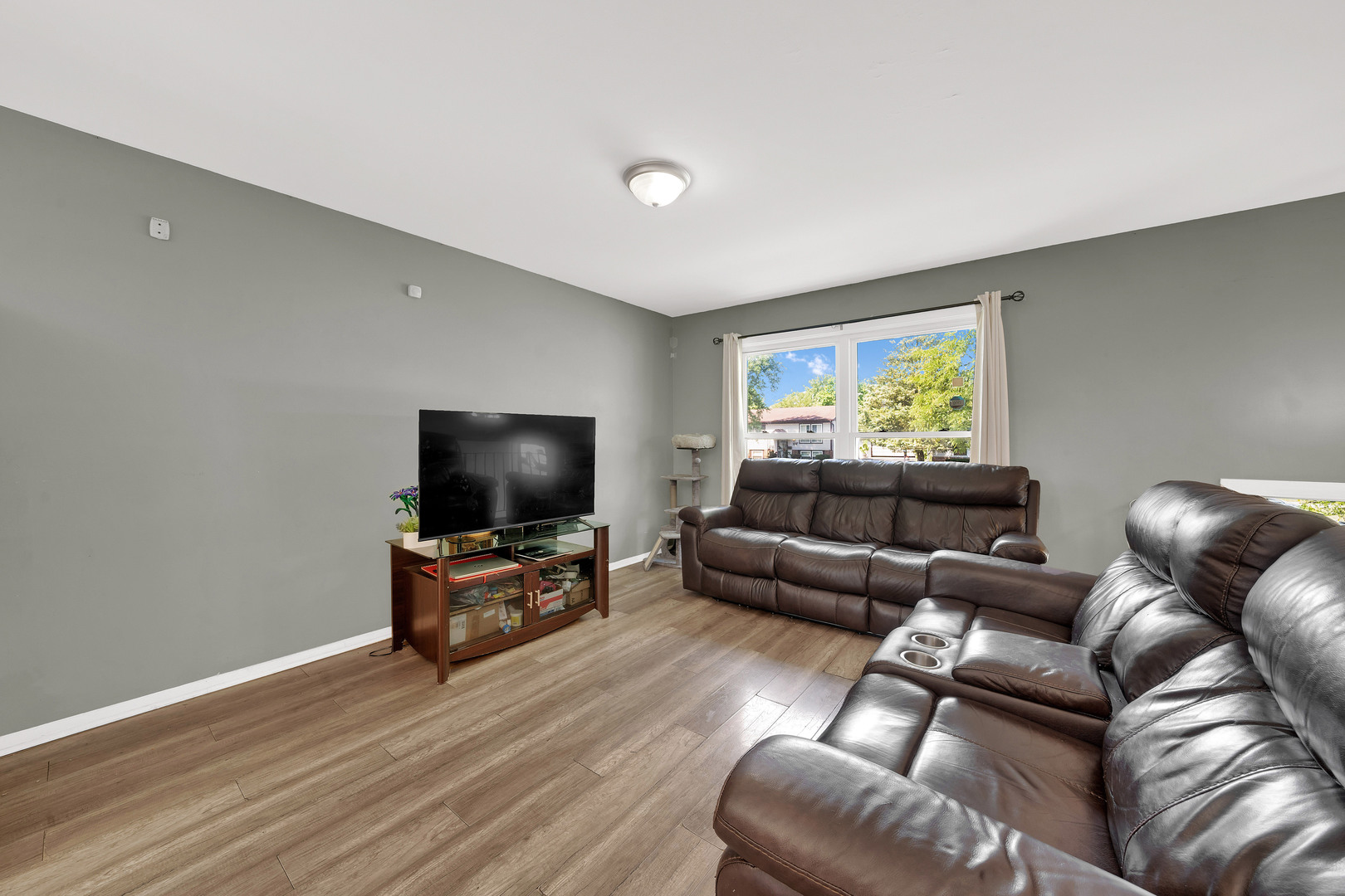 17303 Apple Tree Drive Hazel Crest, IL 60429 - Photo 5 of 23 a living room with furniture and a flat screen tv