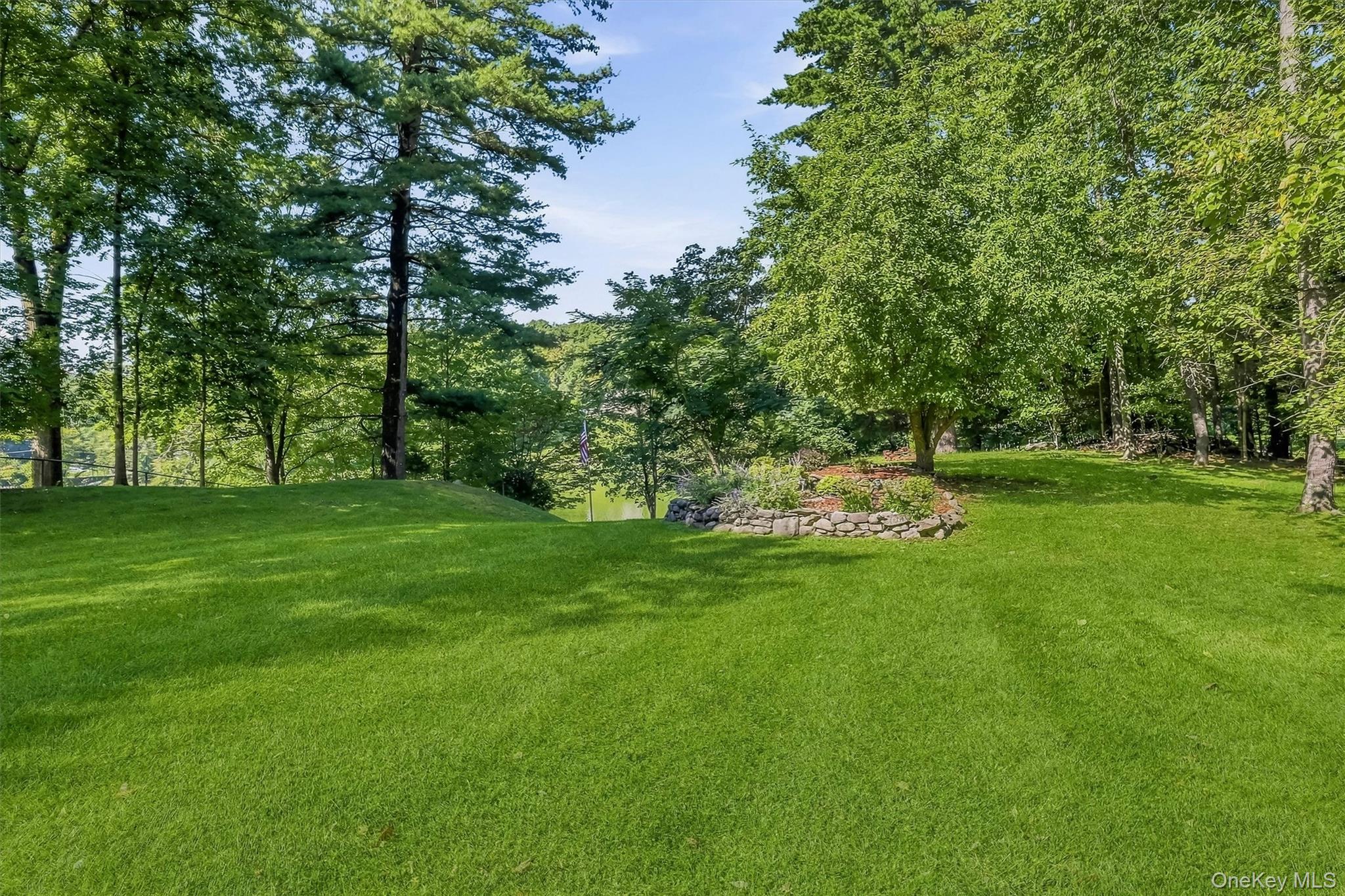 9 Short Road New Windsor, NY 12553 - Photo 38 of 48 Beautifully landscaped grounds gently slope toward the water, creating a private lakeside retreat.