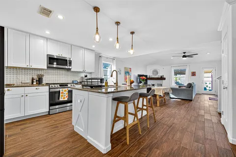a view of a hallway view with wooden floor and staircase