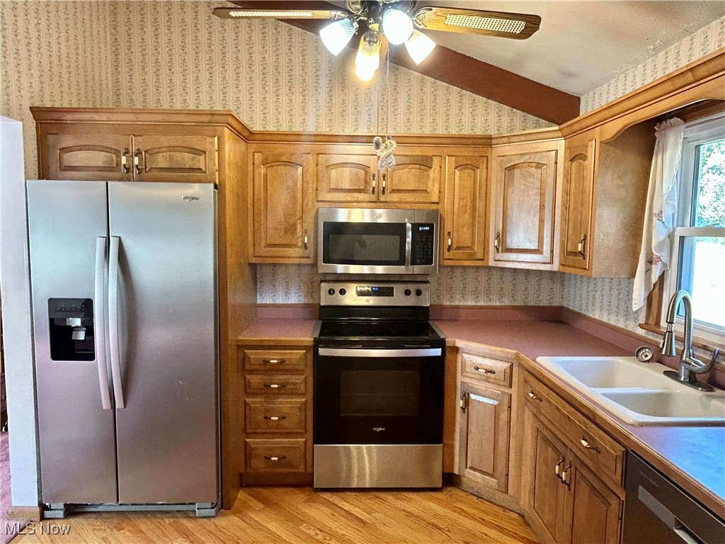 399 Abbyshire Road Green, OH 44319 - Photo 24 of 48 Kitchen with wallpapered walls, stainless steel appliances, wood floors, solid hardwood cabinets, and a ceiling fan