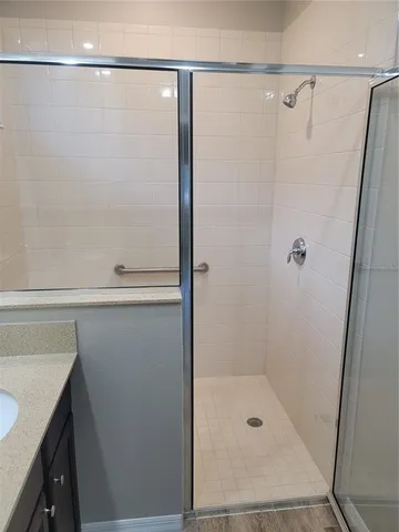 a bathroom with a shower and a sink