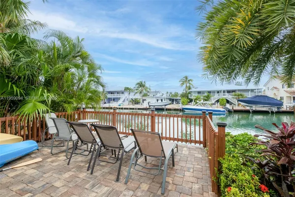 a view of a chair and tables on the patio