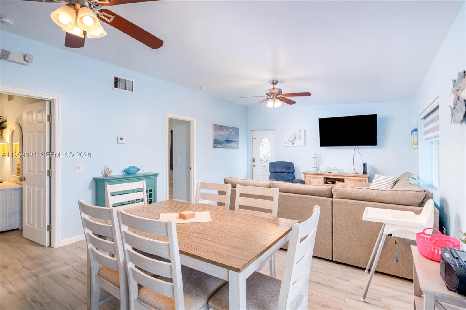 410 10th Street Key Colony Beach, FL 33051 - Photo 11 of 62 a view of a dining room with furniture and a flat screen tv