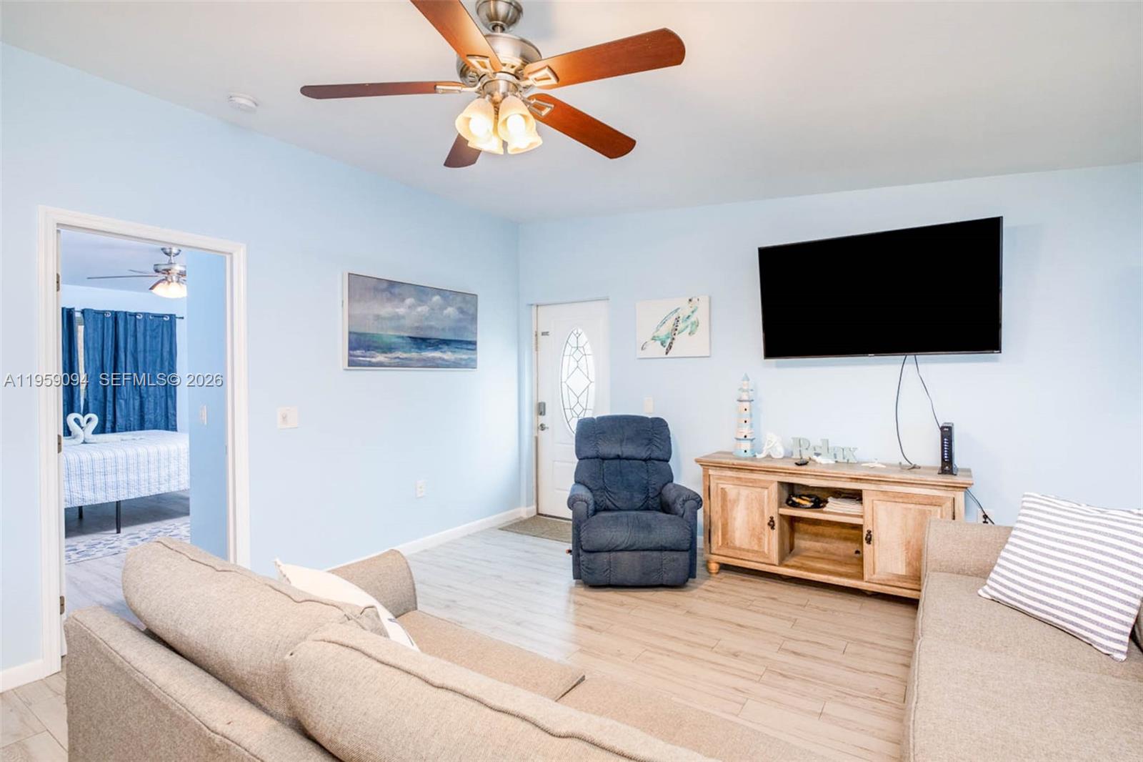 410 10th Street Key Colony Beach, FL 33051 - Photo 12 of 62 a living room with furniture and a flat screen tv