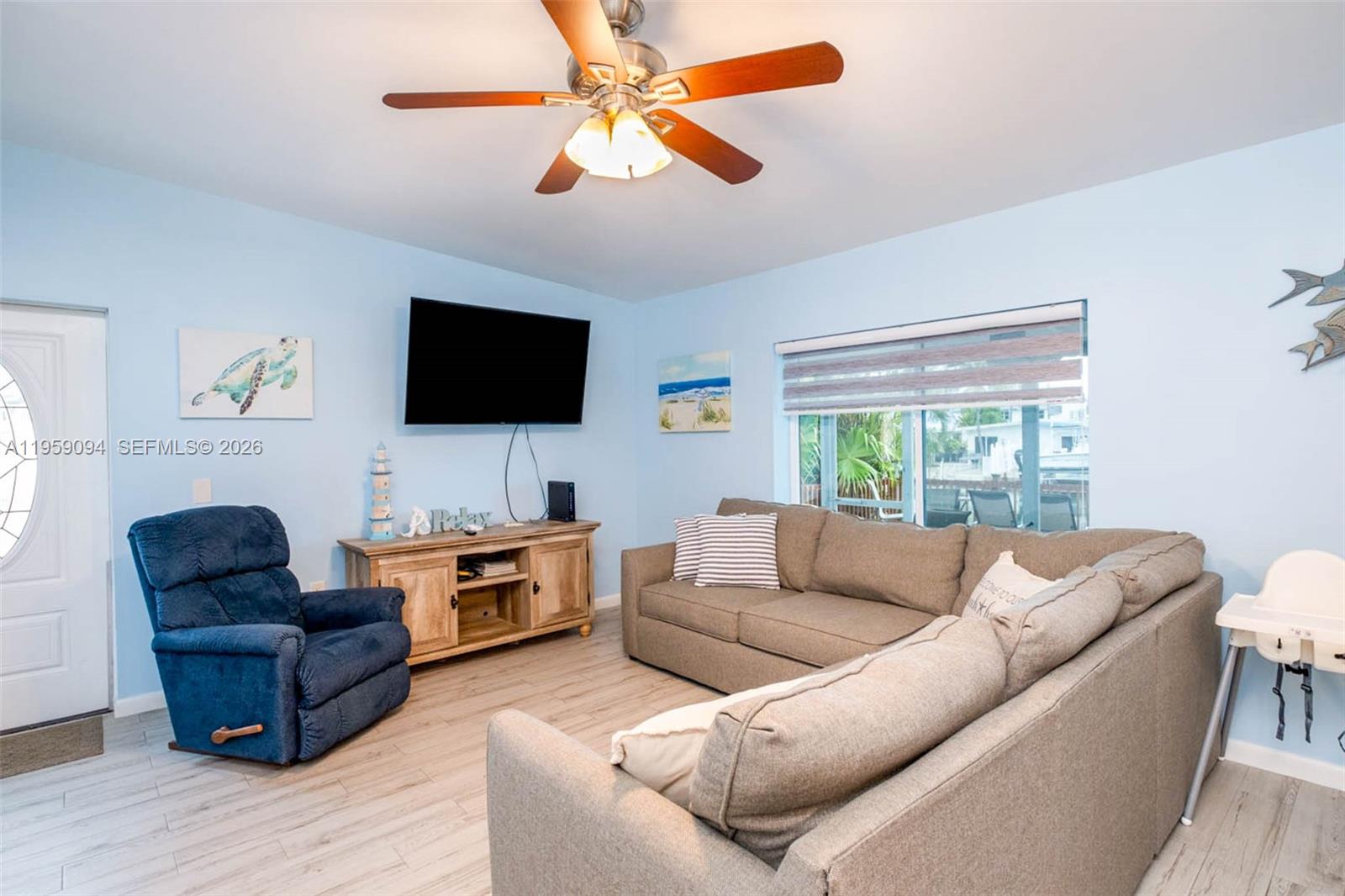 410 10th Street Key Colony Beach, FL 33051 - Photo 12 of 62 a living room with furniture and a flat screen tv