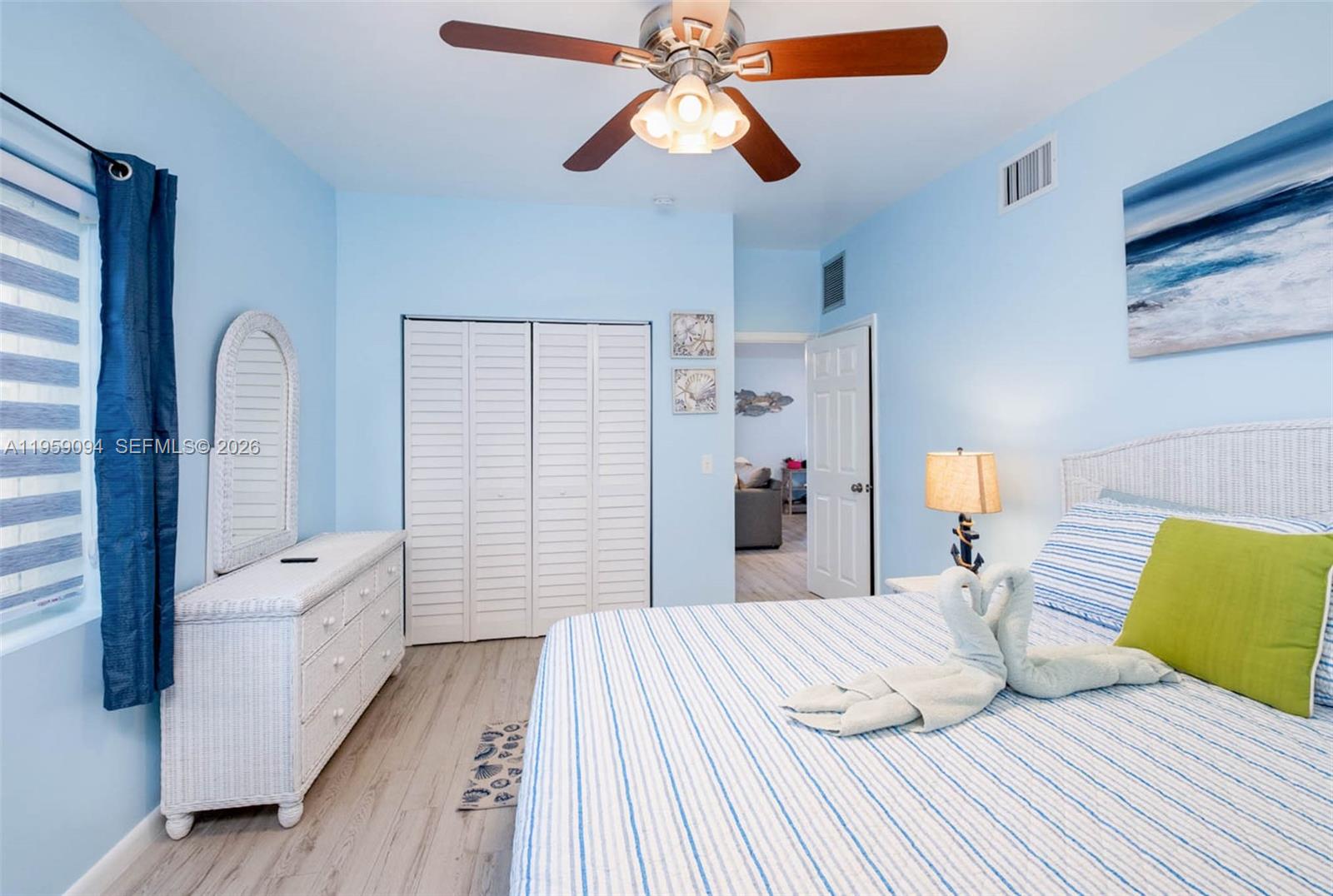 410 10th Street Key Colony Beach, FL 33051 - Photo 16 of 62 a bedroom with a bed and a chandelier
